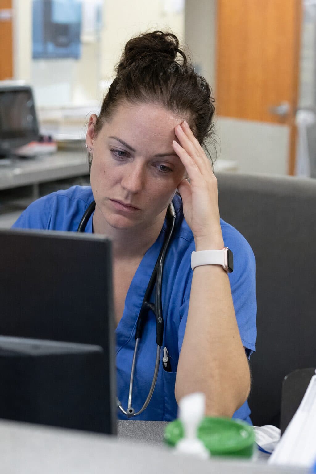 A nurse on the floor, composed and matter-of-fact